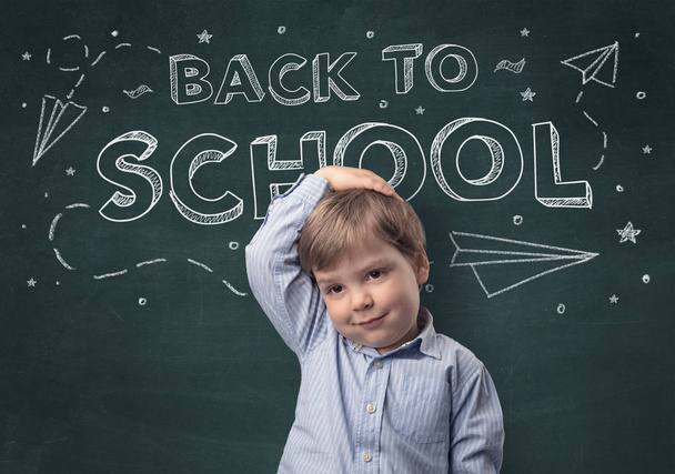 Adorable little boy with blackboard and back to school concept - Fotó, kép