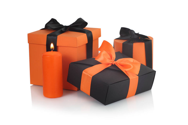 Decorated black and orange halloween gift boxes isolated on white background with reflection - Fotó, kép