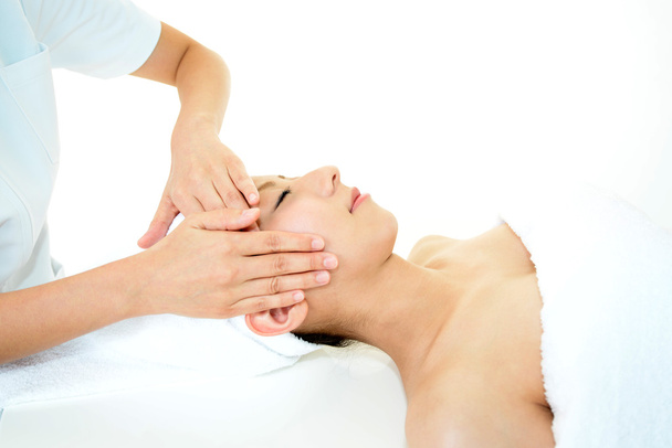 Beautiful young woman receiving facial massage - Фото, изображение
