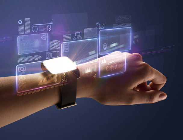 Female hand with smartwatch and dark background - Φωτογραφία, εικόνα