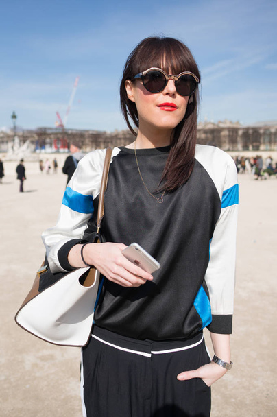 PARIS - OCTOBER 2016: Stylish woman during Paris Fashion week. With Fashion week in New York, London and Milan, they are the four biggest fashion events in the world - 写真・画像