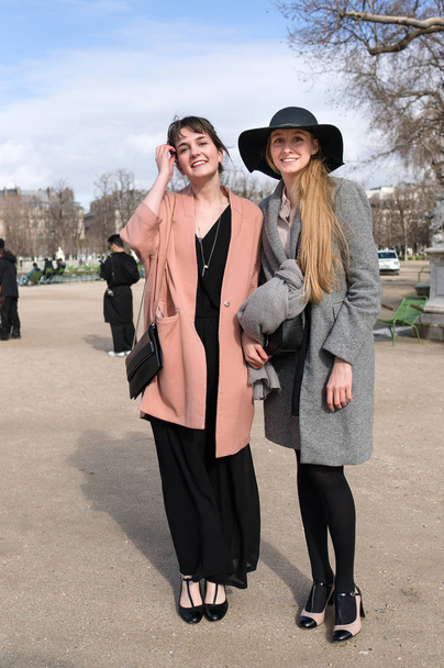 PARIS - OCTOBER 2016: Stylish women during Paris Fashion week. With Fashion week in New York, London and Milan, they are the four biggest fashion events in the world - Valokuva, kuva