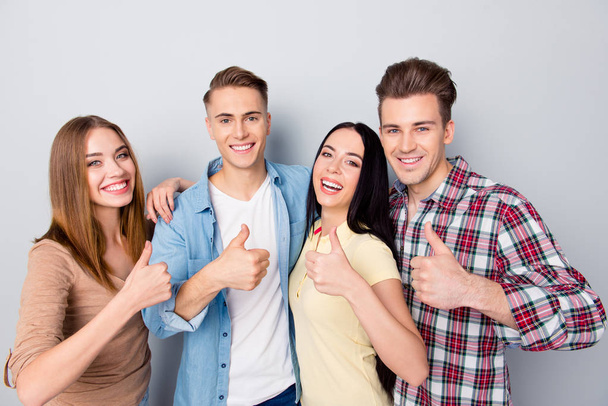 Four attractive nice young friends smiling, standing together, w - Foto, Imagen
