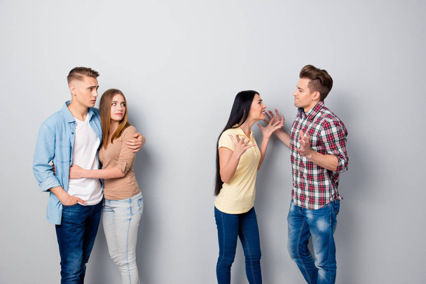 Wife and husband quarrel gesticulating with their friends stand  - Photo, Image