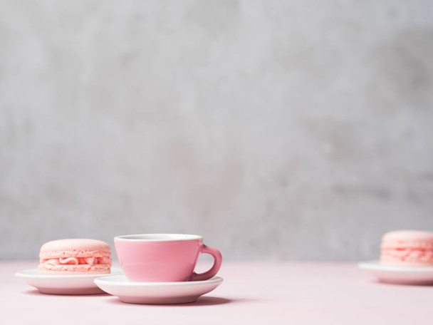 cup of tea served with fresh strawberry macaroons on stone grey background - Фото, изображение