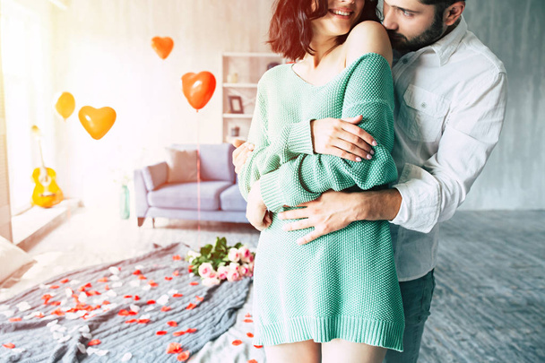 Young man hugging woman in bedroom - Foto, immagini
