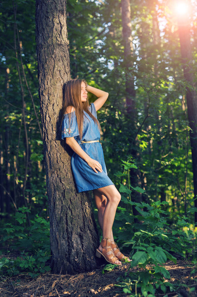 Nature, summer and people concept - Portrait of romantic young woman in forest - Foto, Bild