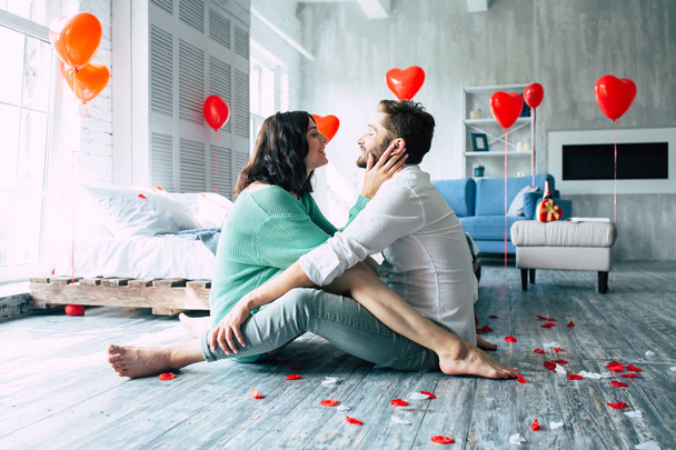 Young couple hugging on floor in bedroom - Photo, Image