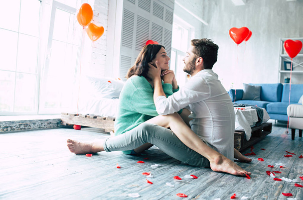 Young couple hugging on floor in bedroom - Photo, image