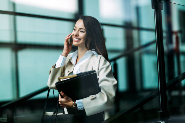 Portrait of young attractive businesswoman going to office - Foto, afbeelding