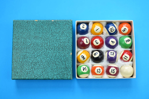 Billar de billar usado bolas con caja de números sobre fondo azul
 - Foto, imagen