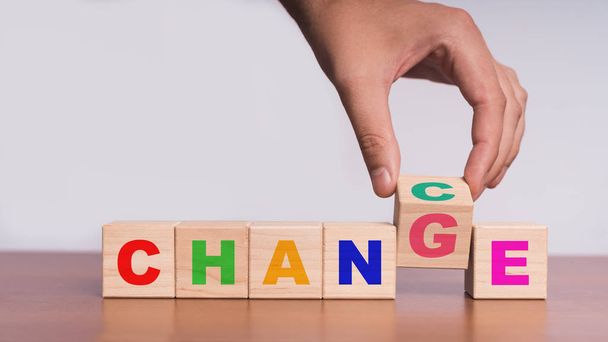 Hand hold flip wooden cube with word "change" to "chance" - Photo, image