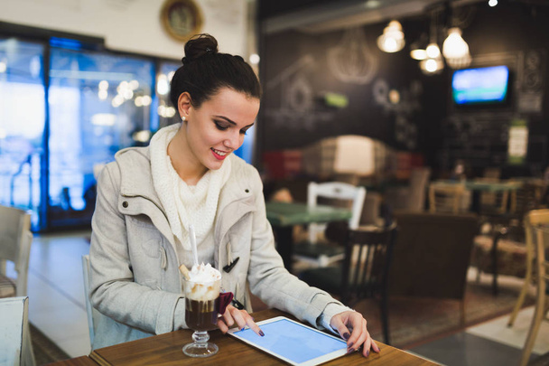 Attractive young woman using digital tablet in cafe - Φωτογραφία, εικόνα