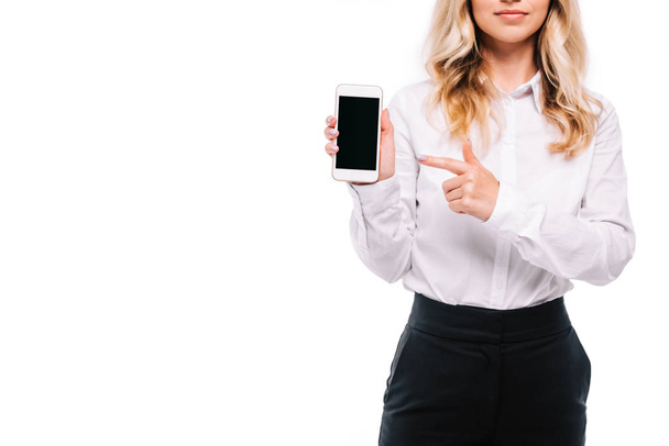 cropped image of businesswoman pointing on smartphone with blank screen isolated on white - Foto, afbeelding
