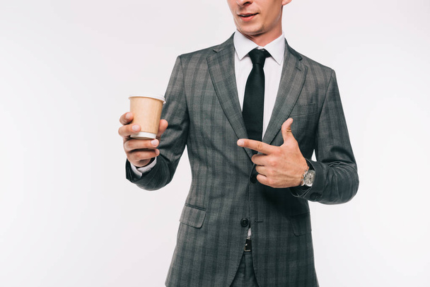 cropped image of businessman pointing on coffee in paper cup isolated on white - Photo, Image