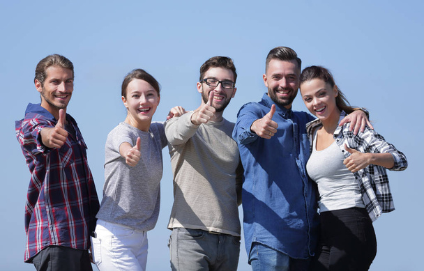 group of young people showing thumb up - Foto, Bild