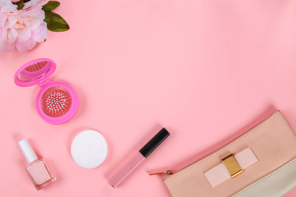 Beauty set with decorative cosmetics. nail polish, brushes and bag on pink background top view mockup - Zdjęcie, obraz