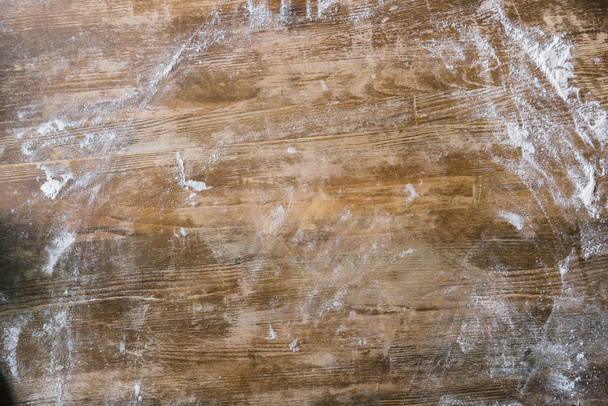 top view of rustic wooden table covered with flour - Foto, Imagem