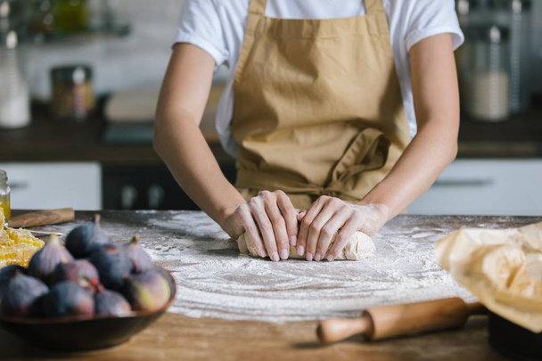 cropped shot of woman kneading dough for pie on rustic wooden table - Photo, Image