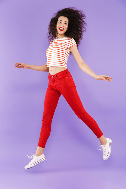 Full length portrait of a pretty young casual woman jumping isolated - Photo, Image
