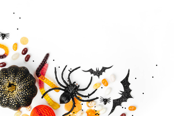 Halloween holiday background with candies, bats, spiders, pumpkins and decorations - Photo, Image