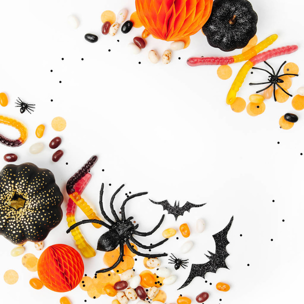 Halloween holiday background with candies, bats, spiders, pumpkins and decorations - 写真・画像