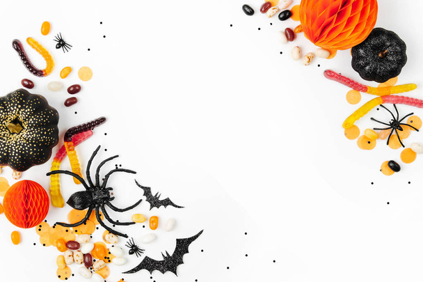 Halloween holiday background with candies, bats, spiders, pumpkins and decorations - Photo, image
