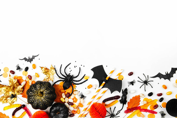 Halloween holiday background with candies, bats, spiders, pumpkins and decorations - Φωτογραφία, εικόνα