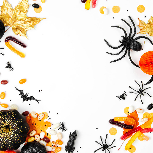 Halloween holiday background with candies, bats, spiders, pumpkins and decorations - Photo, Image