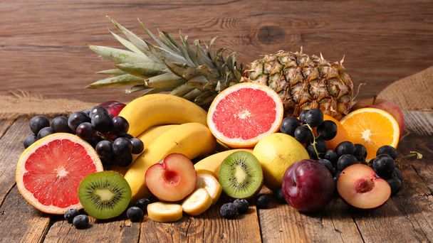 pile of various fruit on wooden surface - Photo, Image