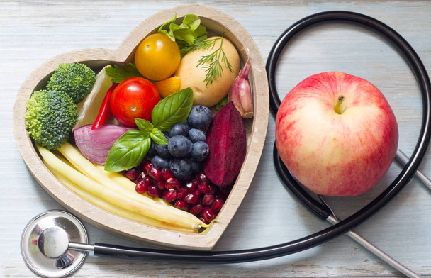 Healthy food in heart diet concept with stethoscope - Φωτογραφία, εικόνα