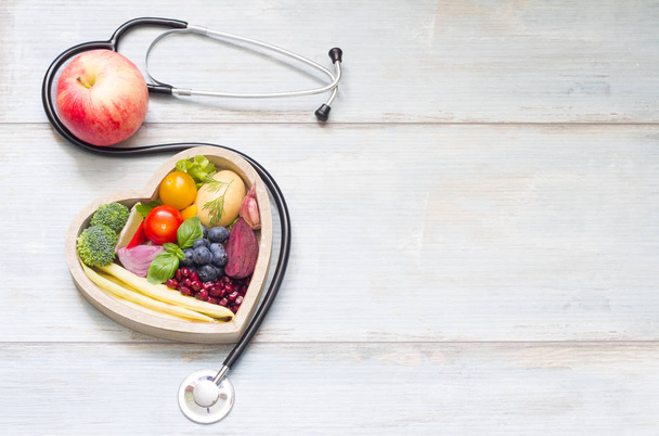 Healthy food in heart diet concept with stethoscope - Фото, изображение