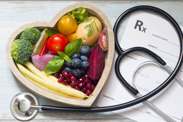Healthy food in heart stethoscope and medical prescription diet and medicine concept - Φωτογραφία, εικόνα