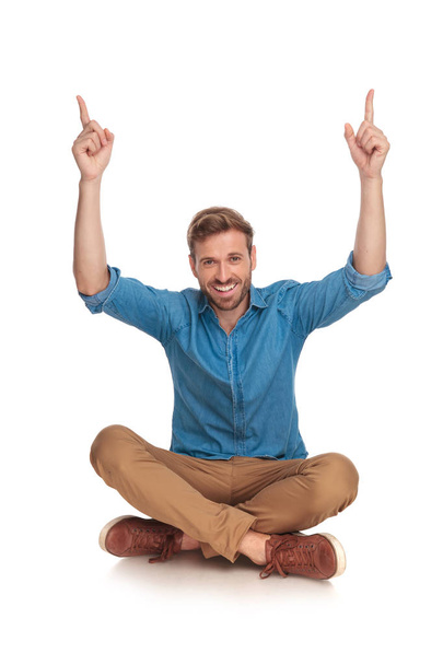 happy young man with hands in the air celebrating success on white background - Photo, Image