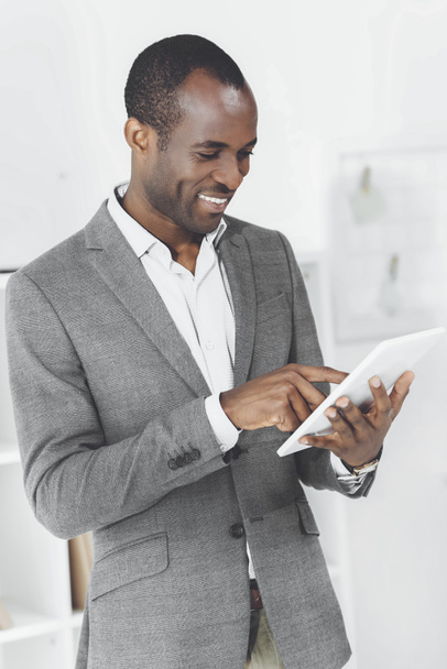 smiling african american man using tablet - Photo, Image