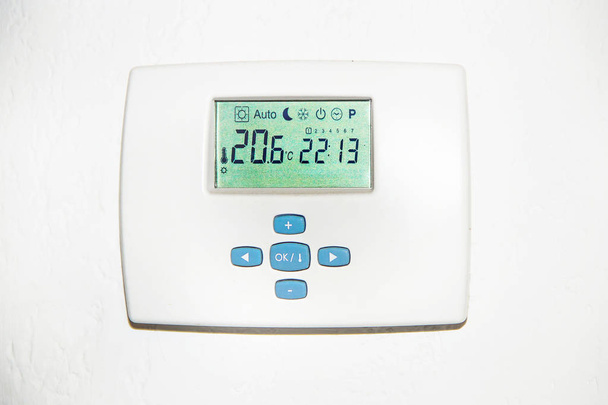  Adjusting a digital thermostat to save energy - Photo, Image