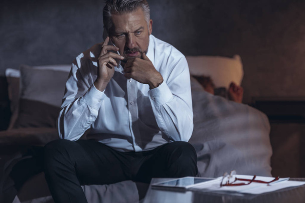 Tired businessman talking on the phone. Problem of lack of time for family life - Fotoğraf, Görsel