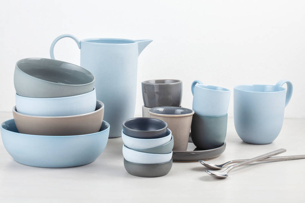 Collection of different dishes, plates, bowls and cups in blue and grey colos - 写真・画像