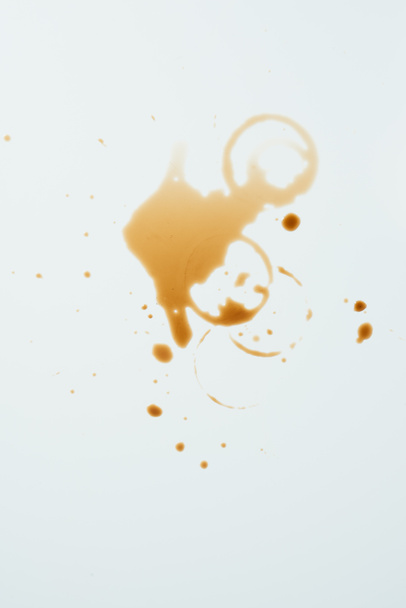 Draufsicht auf die unordentliche weiße Oberfläche mit Kaffeekleckern - Foto, Bild