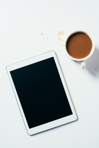 top view of cup of coffee and tablet on white surface - Photo, image