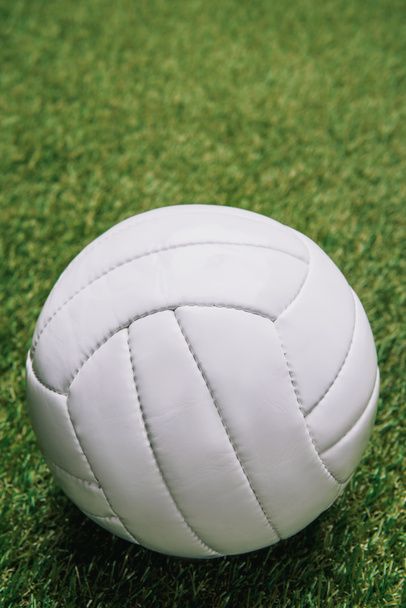 緑の芝生に白いバレーボール ボールのビューをクローズ アップ - 写真・画像