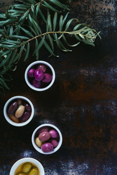 top view of olives for oil preparation in bowls on shabby surface - Fotografie, Obrázek