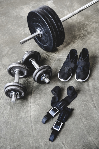 various weight lifting equipment on concrete surface - 写真・画像
