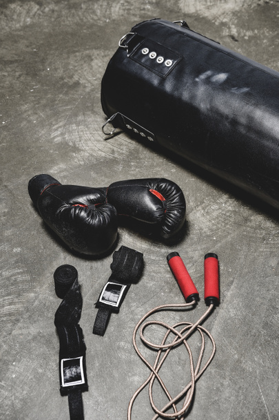 different boxing equipment lying on concrete surface - Photo, Image