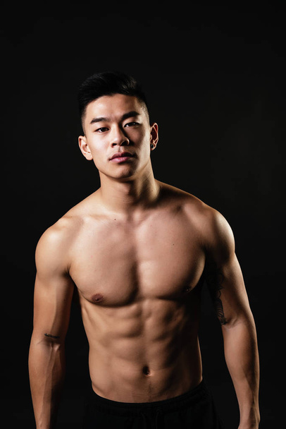 Portrait of young asian boy with fitness body. Challenging attitude - Φωτογραφία, εικόνα