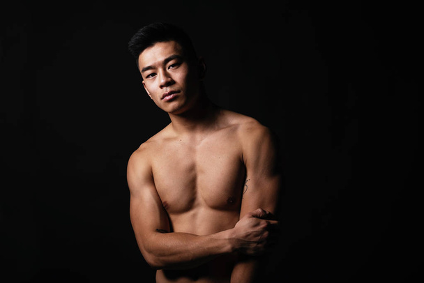 Portrait of young asian boy with fitness body. Challenging attitude - Фото, зображення