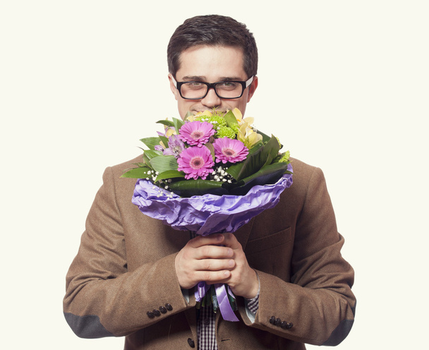 man with flowers in hand - Foto, afbeelding