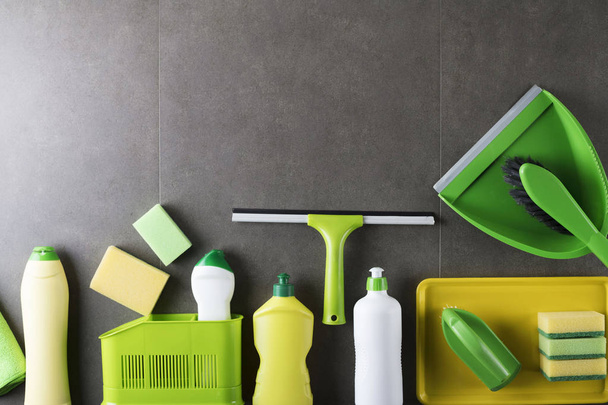 House and office cleaning up theme.  Set of colorful cleaning products on gray tiles.  background. Top view.  Place for logo, text or typography. - Photo, image