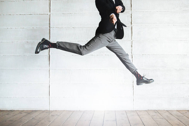 jumping man in black costume in the office - Foto, Bild