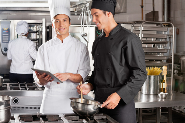 Chef Assisting Colleague In Preparing Food - Фото, зображення